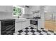 Bright, modern kitchen with white cabinets, stainless steel appliances, and checkered flooring at 315 Renae, Marietta, GA 30060
