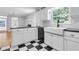 Modern kitchen with white cabinets, black countertops, and a checkered floor pattern at 315 Renae, Marietta, GA 30060