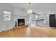 Open concept living room featuring a fireplace, hardwood floors, and an adjacent modern kitchen at 315 Renae, Marietta, GA 30060