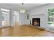Inviting living room with a cozy fireplace, hardwood floors, and natural light from the windows at 315 Renae, Marietta, GA 30060