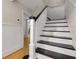 Staircase featuring a white railing with black accents and hardwood floors at 315 Renae, Marietta, GA 30060