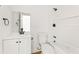 Bright bathroom featuring a vanity and a tub with white cabinets and a shower at 4103 Brenda Dr, Decatur, GA 30035