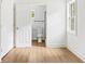 Bedroom with wood-look floors, white walls, and a doorway to a bathroom at 4103 Brenda Dr, Decatur, GA 30035