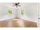 Bright bedroom with wood-look floors, white walls, and lots of natural light from the windows at 4103 Brenda Dr, Decatur, GA 30035