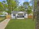 Charming renovated home featuring a cozy front porch and freshly manicured lawn at 4103 Brenda Dr, Decatur, GA 30035
