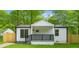 Charming home with a covered front porch, black railing, large window, and fenced yard at 4103 Brenda Dr, Decatur, GA 30035