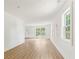 Bright, open living space with wood-look floors, white walls, and lots of natural light from the windows at 4103 Brenda Dr, Decatur, GA 30035