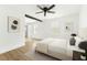 Bright main bedroom with neutral decor, wood-look floors, and decorative beam at 4103 Brenda Dr, Decatur, GA 30035