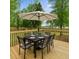 Outdoor wooden deck with a dining table and chairs, and a white patio umbrella at 4103 Brenda Dr, Decatur, GA 30035