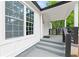 Inviting front porch with stylish gray painted steps, white trim, and dark wood railing, enhancing curb appeal at 4103 Brenda Dr, Decatur, GA 30035