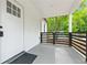 Close-up of a welcoming covered front porch with black railing, white trim, and a clean, modern aesthetic at 4103 Brenda Dr, Decatur, GA 30035