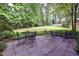 Spacious backyard with patio area, table and chairs, and beautifully maintained lawn at 4314 Woodhaven Se Way, Smyrna, GA 30082