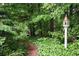 Landscaped backyard with winding pine needle trail and birdhouse at 4314 Woodhaven Se Way, Smyrna, GA 30082
