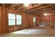 Unfinished basement with exposed wood framing and natural light from two windows at 4314 Woodhaven Se Way, Smyrna, GA 30082