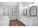 Bathroom boasts double vanity, tiled floors, frameless glass shower door and separate tub at 4314 Woodhaven Se Way, Smyrna, GA 30082