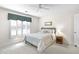 Bright bedroom with a ceiling fan, large windows, and a cozy bed with soft pillows at 4314 Woodhaven Se Way, Smyrna, GA 30082