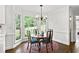 Inviting dining area featuring a wooden table set, hardwood floors, and a large window with a backyard view at 4314 Woodhaven Se Way, Smyrna, GA 30082