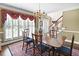 Formal dining room with large windows, natural light, and staircase to the second floor at 4314 Woodhaven Se Way, Smyrna, GA 30082