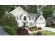 Elegant home featuring large windows, blue shutters, and a two-car garage at 4314 Woodhaven Se Way, Smyrna, GA 30082