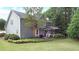 Back exterior view featuring a screened porch, patio, lush landscaping and large backyard at 4314 Woodhaven Se Way, Smyrna, GA 30082