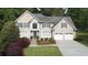 Charming two-story home features an attached two-car garage, and a beautifully landscaped yard with mature trees at 4314 Woodhaven Se Way, Smyrna, GA 30082