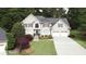 Traditional home with two-car garage, manicured lawn, and mature trees at 4314 Woodhaven Se Way, Smyrna, GA 30082
