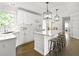 Bright kitchen features white cabinetry, modern stainless steel appliances, large island and hardwood flooring at 4314 Woodhaven Se Way, Smyrna, GA 30082