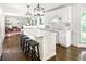 Bright, modern kitchen featuring white cabinets, a center island with seating, and stainless steel appliances at 4314 Woodhaven Se Way, Smyrna, GA 30082