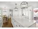 Open kitchen featuring a large center island with a white countertop and pendant lighting at 4314 Woodhaven Se Way, Smyrna, GA 30082