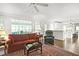 Spacious living room with hardwood floors, large windows and open access to a modern, all-white kitchen at 4314 Woodhaven Se Way, Smyrna, GA 30082
