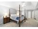 Spacious main bedroom features a four-poster bed, ceiling fan, and neutral carpeting at 4314 Woodhaven Se Way, Smyrna, GA 30082