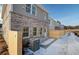 Rear exterior of the townhouse with a small patio and fenced yard; shows the gray brick and siding at 4511 Twinberry Dr, Powder Springs, GA 30127