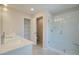 Bathroom showcasing double sinks, walk-in shower and separate closet with wire shelving at 4511 Twinberry Dr, Powder Springs, GA 30127