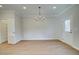 Dining room with luxury vinyl plank flooring, modern chandelier, and neutral walls at 4511 Twinberry Dr, Powder Springs, GA 30127