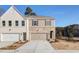 Newly constructed two-story home featuring a painted brick facade and neutral color scheme at 4511 Twinberry Dr, Powder Springs, GA 30127