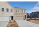 Modern townhome with light brick and siding, featuring an attached one-car garage at 4511 Twinberry Dr, Powder Springs, GA 30127