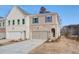 View of a modern townhome with a one car garage and stylish mixed material facade at 4511 Twinberry Dr, Powder Springs, GA 30127