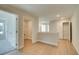 Hallway with wood floors featuring white trim, doors, and carpeted bedrooms on either side at 4511 Twinberry Dr, Powder Springs, GA 30127