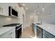Updated kitchen with stainless steel appliances, gray island, and modern lighting at 4511 Twinberry Dr, Powder Springs, GA 30127