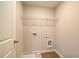Compact laundry room with utility sink and wire shelving; washer and dryer hookups at 4511 Twinberry Dr, Powder Springs, GA 30127