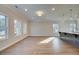 Bright open-concept with neutral walls, luxury vinyl flooring, and modern pendant lights at 4511 Twinberry Dr, Powder Springs, GA 30127