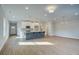 Open-concept living space with gray island, stainless appliances, and hardwood floors at 4511 Twinberry Dr, Powder Springs, GA 30127