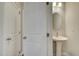 Bathroom with pedestal sink, oval mirror, and modern lighting fixture at 4511 Twinberry Dr, Powder Springs, GA 30127