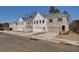 New townhomes with painted brick and siding exteriors, each featuring attached garages and driveways at 4511 Twinberry Dr, Powder Springs, GA 30127