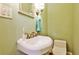 Powder room with a pedestal sink, toilet, and framed mirror at 50 Rumson Ne Way, Atlanta, GA 30305