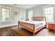 Bedroom with hardwood floors, three windows, and a wooden bed frame at 50 Rumson Ne Way, Atlanta, GA 30305