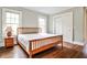 Bedroom with hardwood floors, closet, two windows, and a wooden bed frame at 50 Rumson Ne Way, Atlanta, GA 30305