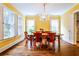 Bright dining room with hardwood floors, chandelier, and three windows letting in natural light at 50 Rumson Ne Way, Atlanta, GA 30305