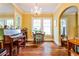 Sunny dining room featuring a piano, hardwood floors, and elegant chandelier at 50 Rumson Ne Way, Atlanta, GA 30305