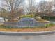 Historic Garden Hills neighborhood entrance featuring a stone monument surrounded by vibrant landscaping at 50 Rumson Ne Way, Atlanta, GA 30305